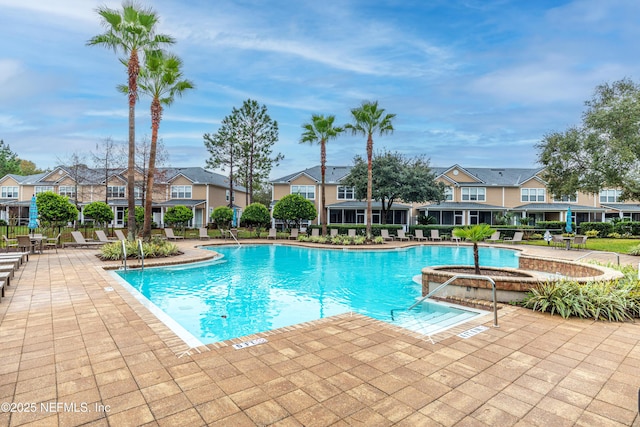 community pool featuring a patio area and a residential view