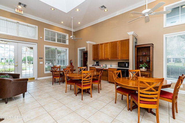 dining room with ornamental molding, visible vents, and a ceiling fan