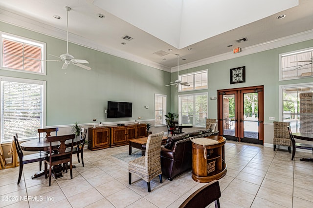 living room featuring visible vents, a towering ceiling, and light tile patterned floors