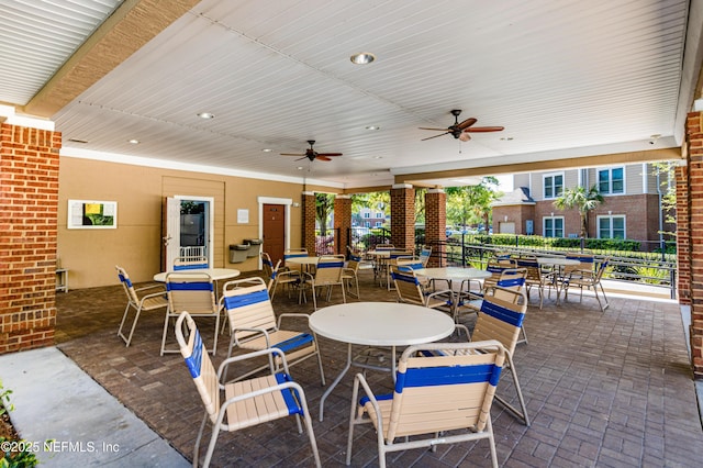 view of patio / terrace featuring a ceiling fan, outdoor dining area, and fence