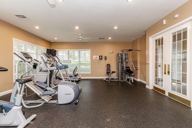 workout area featuring baseboards, visible vents, a textured ceiling, and french doors