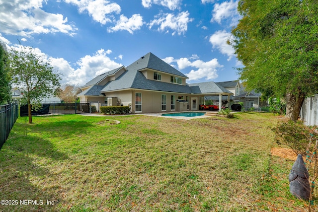 back of property with a yard, a fenced in pool, a fenced backyard, and a patio area