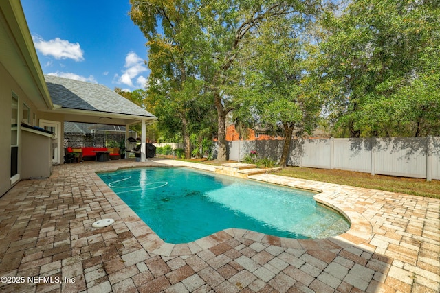 view of swimming pool featuring a fenced in pool, a patio, and a fenced backyard