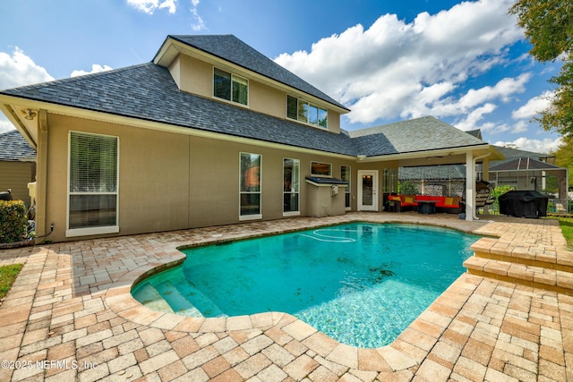 pool with a patio area and grilling area