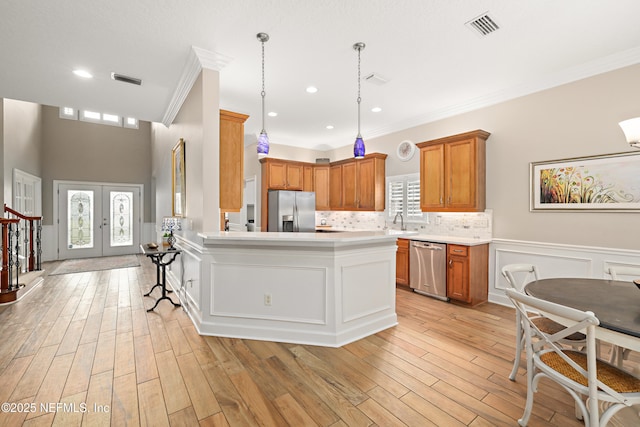 kitchen with visible vents, a sink, french doors, appliances with stainless steel finishes, and light countertops