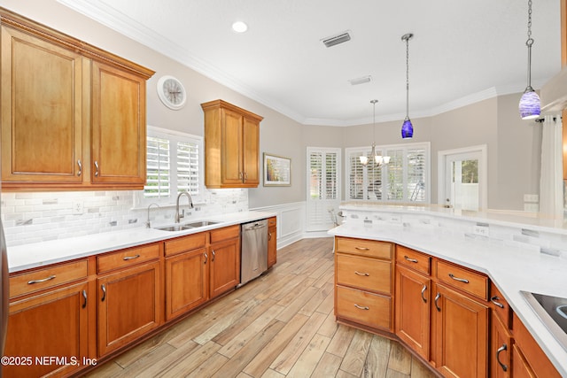 kitchen featuring a sink, dishwasher, ornamental molding, and light wood finished floors