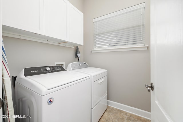 clothes washing area featuring cabinet space, baseboards, and separate washer and dryer