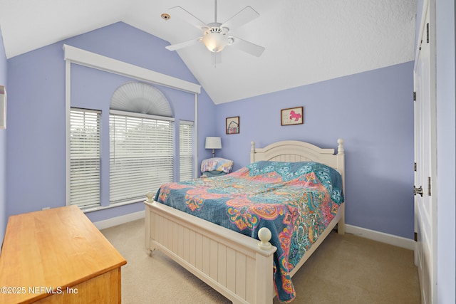 bedroom featuring light colored carpet, baseboards, lofted ceiling, and ceiling fan