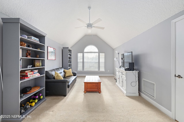 living area with vaulted ceiling, visible vents, carpet floors, and a textured ceiling