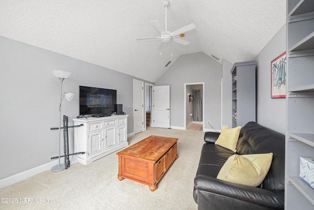 living area featuring ceiling fan, vaulted ceiling, baseboards, and light carpet