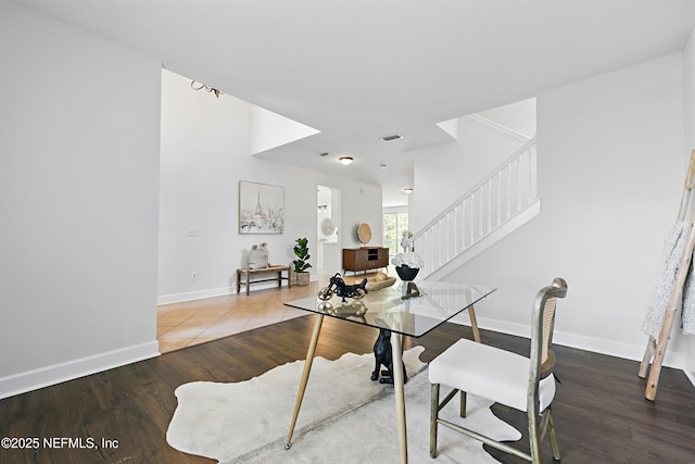 office area featuring wood finished floors, visible vents, and baseboards