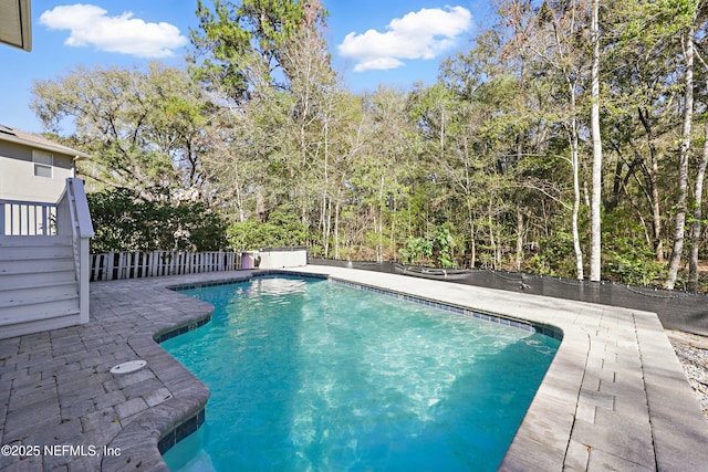 view of swimming pool with a patio, fence, and a fenced in pool