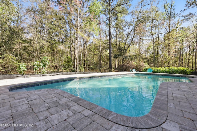 outdoor pool featuring a patio area