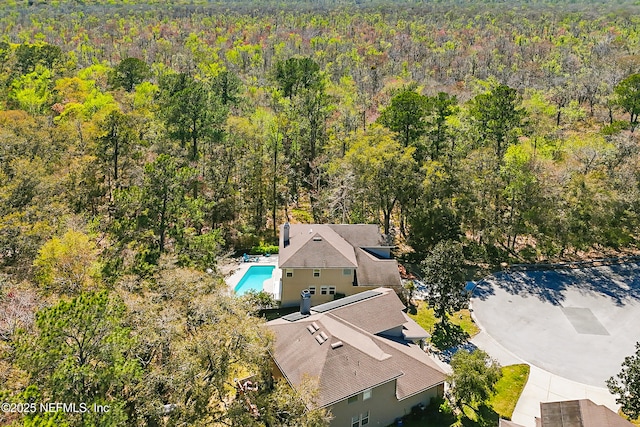 drone / aerial view featuring a forest view