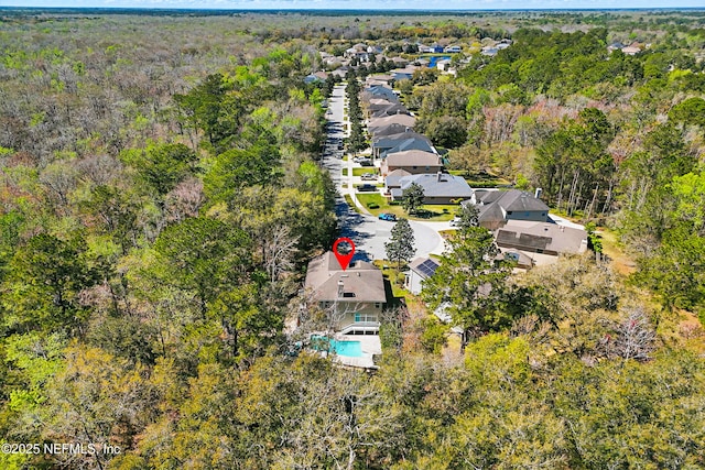 bird's eye view with a wooded view and a residential view