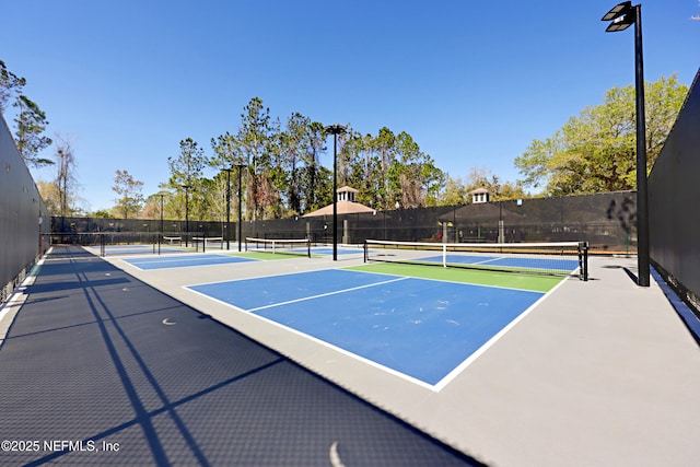 view of sport court featuring fence