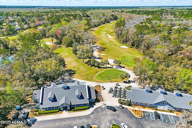 birds eye view of property featuring a forest view and golf course view