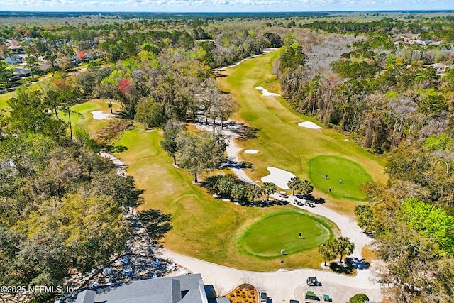 birds eye view of property with a forest view and golf course view