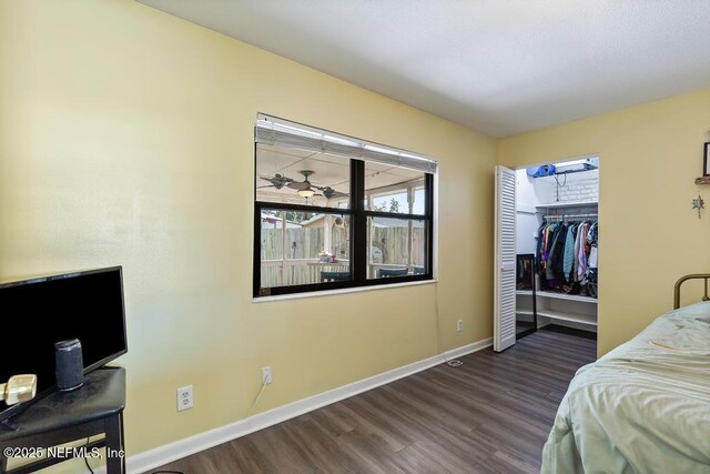 bedroom featuring a closet, baseboards, and wood finished floors