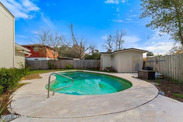 view of pool with a storage shed, a patio, an outdoor structure, and a fenced backyard