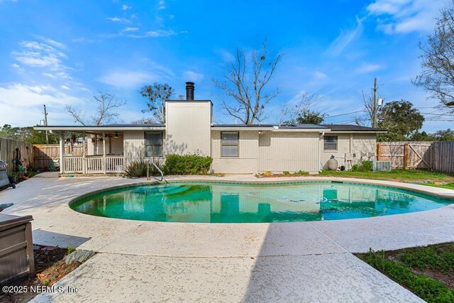 view of pool with a fenced in pool, a patio area, a fenced backyard, and central AC unit