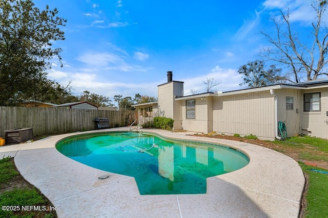 view of pool featuring a patio area, a fenced backyard, and a fenced in pool