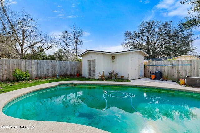 view of swimming pool featuring a fenced in pool, an outbuilding, and a fenced backyard