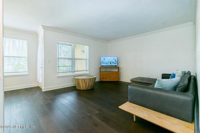 living area with plenty of natural light, baseboards, dark wood-style flooring, and crown molding