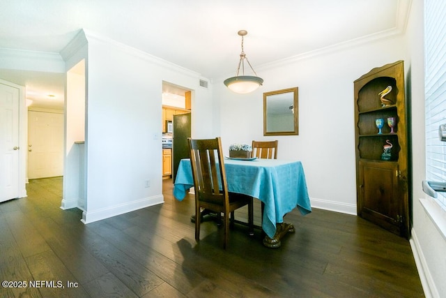 dining area with ornamental molding, dark wood-style flooring, visible vents, and baseboards