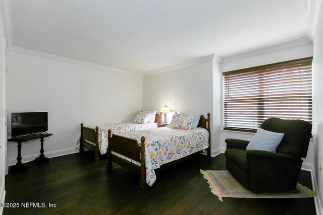 bedroom featuring crown molding, baseboards, and wood finished floors