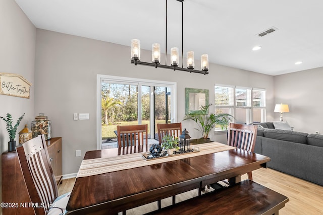 dining room with light wood-type flooring, baseboards, visible vents, and recessed lighting