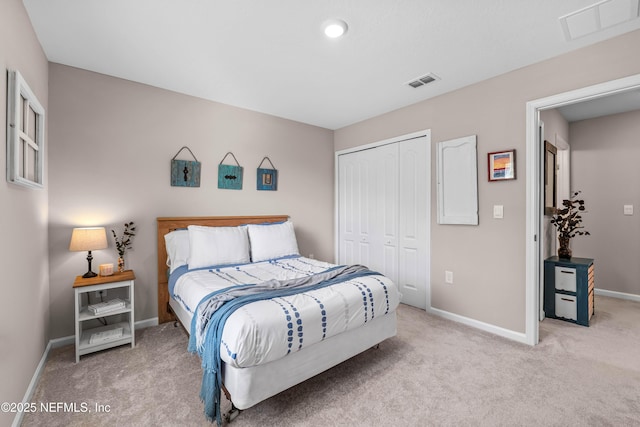 carpeted bedroom featuring a closet, visible vents, and baseboards