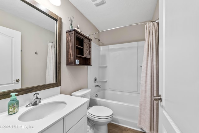 full bath featuring visible vents, toilet, shower / bath combo, vanity, and a textured ceiling