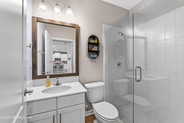 full bath featuring toilet, a shower stall, and vanity