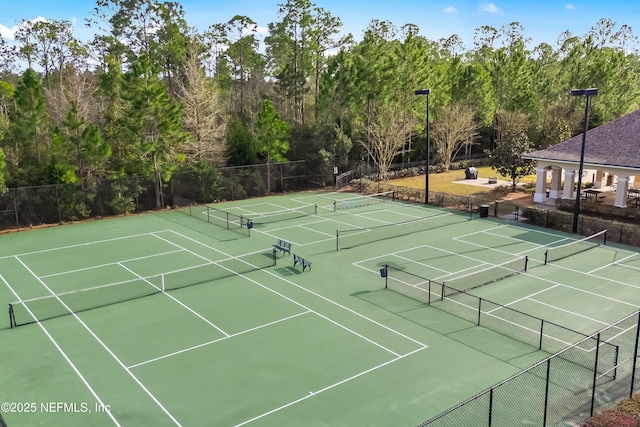 view of sport court featuring fence