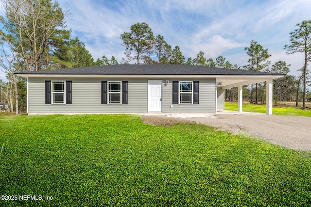 view of front of property with driveway, a front lawn, and an attached carport