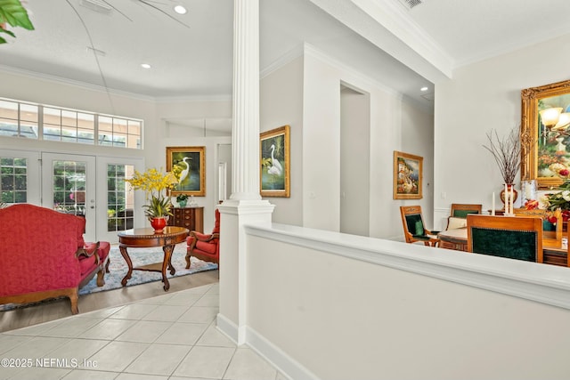 hall with tile patterned flooring, baseboards, ornamental molding, french doors, and ornate columns