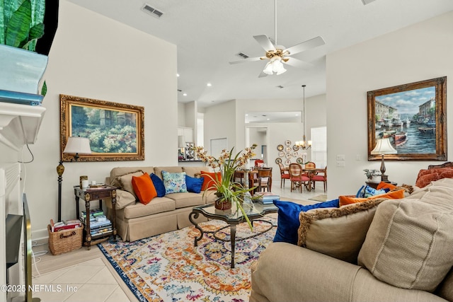 living room with recessed lighting, light tile patterned flooring, ceiling fan with notable chandelier, and visible vents