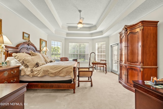 bedroom featuring light carpet, ornamental molding, a tray ceiling, a textured ceiling, and access to exterior