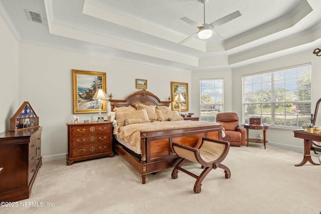 bedroom featuring baseboards, a raised ceiling, light colored carpet, and crown molding