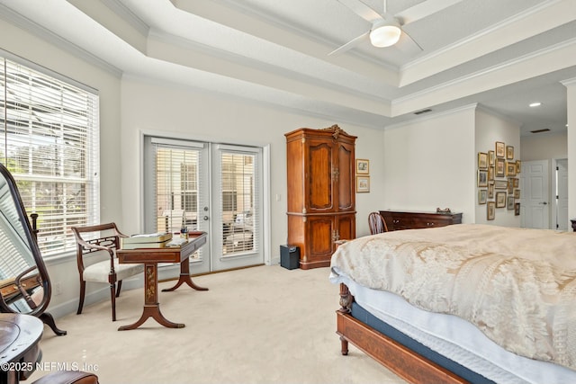 bedroom featuring french doors, a raised ceiling, multiple windows, and access to outside