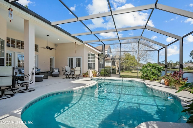 outdoor pool with a patio area, french doors, a lanai, and ceiling fan