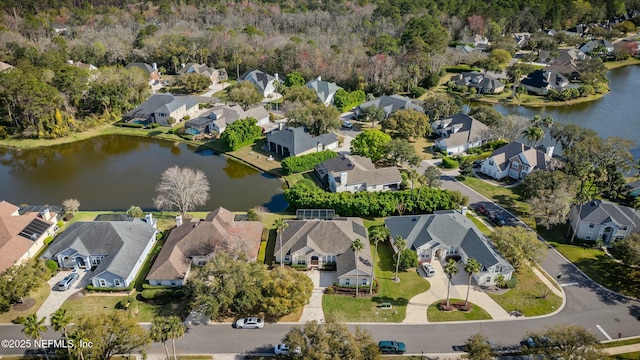 birds eye view of property with a residential view and a water view