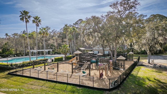 exterior space with a community pool and fence