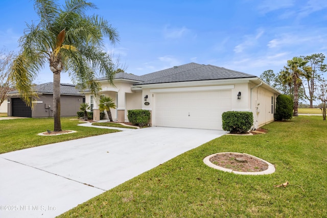 view of front of house featuring a front yard, driveway, an attached garage, and stucco siding