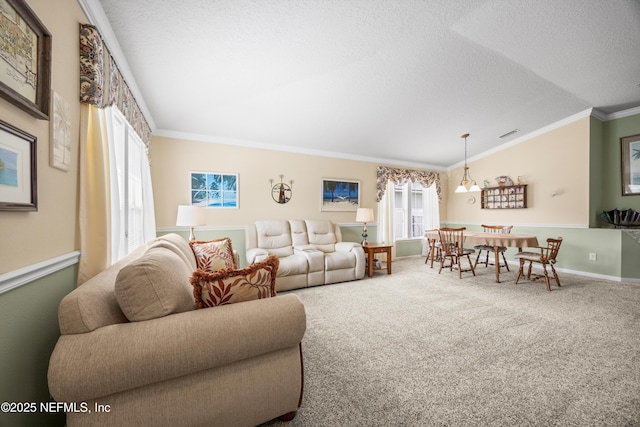 carpeted living room featuring a textured ceiling, ornamental molding, visible vents, and baseboards