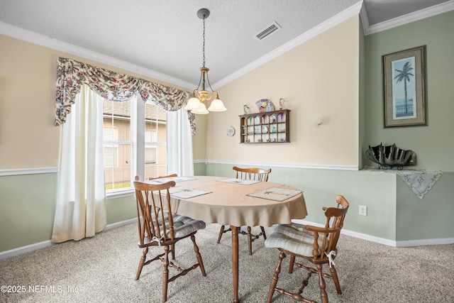 dining room with ornamental molding, carpet flooring, visible vents, and baseboards