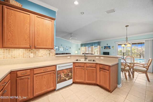 kitchen with lofted ceiling, light countertops, a sink, dishwasher, and a peninsula