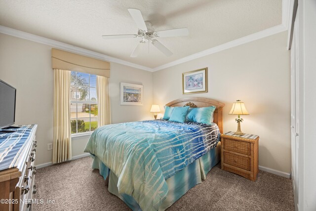 carpeted bedroom with ornamental molding, ceiling fan, and baseboards