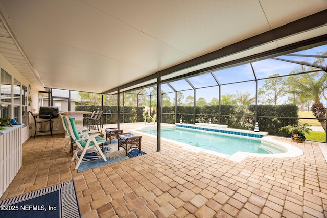 pool featuring a lanai and a patio area